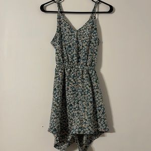 Cute floral romper with tie back. Adjustable straps.